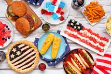 Fourth of July cookout and table scene on a white wood background.