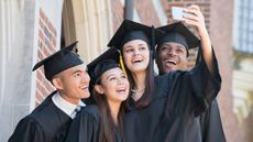 picture of four college graduates taking a selfie