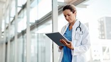 A doctor reviewing records